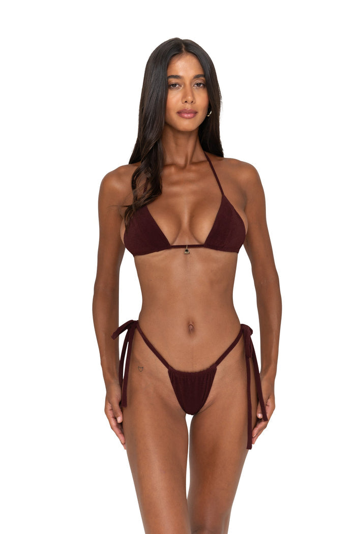Woman wearing a burgundy bikini set on a white background
