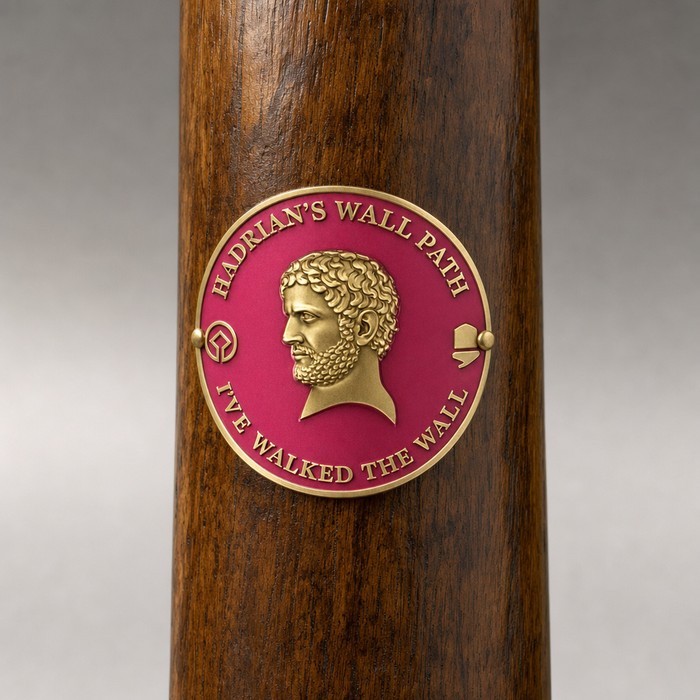 Hadrian's Wall hiking stick medallion installed on a wooden hiking staff