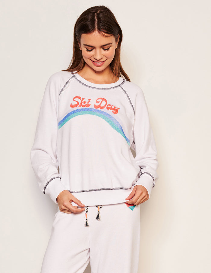 Sundry Ski Day Raglan Sweatshirt in Optic White-model is looking down at her sweatshirt