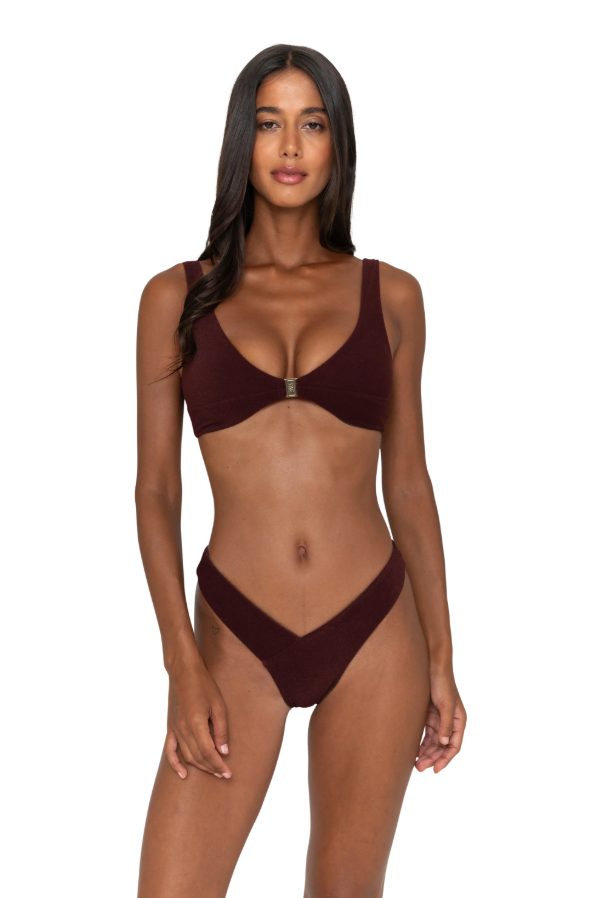 Woman wearing a burgundy bikini on a white background