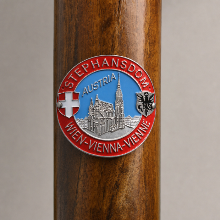 Vienna hiking stick medallion installed on a wooden hiking staff